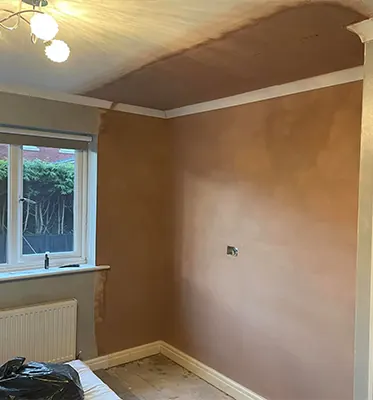 After: The same bedroom with walls and ceiling freshly plastered